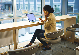 A woman typing on a laptop